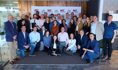 EMBA cohort pose for photo at MIT