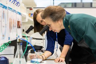HRH The Princess Royal looking in a microscope at the LMS Opening event